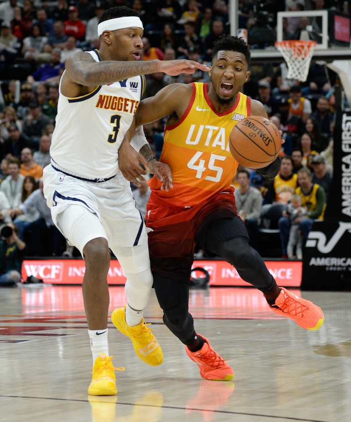 (Francisco Kjolseth  |  The Salt Lake Tribune)  Utah Jazz guard Donovan Mitchell (45) tries to push past Denver Nuggets forward Torrey Craig (3) as the Utah Jazz host the Denver Nuggets in their NBA game at Vivint Smart Home Arena Tuesday, April 9, 2019, in Salt Lake City.