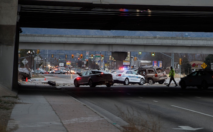 Scott Sommerdorf | The Salt Lake Tribune
The scene of a fatal crash on 3500 South, under the I-215 expressway, Sunday, February, 11, 2018. At the far left is one crashed vehicle, and in the center of the frame, another.