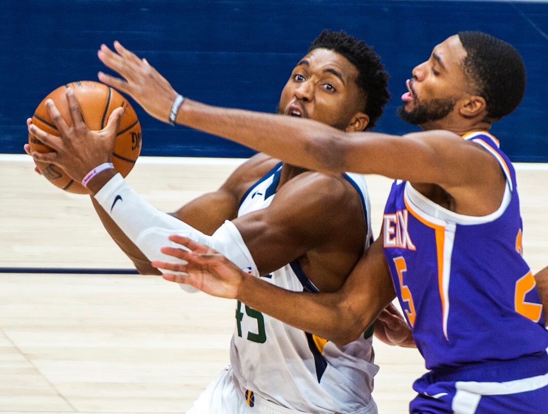 (Rick Egan | The Salt Lake Tribune) Utah Jazz guard Donovan Mitchell (45) takes the ball to the hoop. As Phoenix Suns forward Mikal Bridges (25) defends, in preseason NBA action between Utah Jazz and Phoenix Suns at Vivint SmartHome Area, on Saturday, Dec. 12, 2020.
