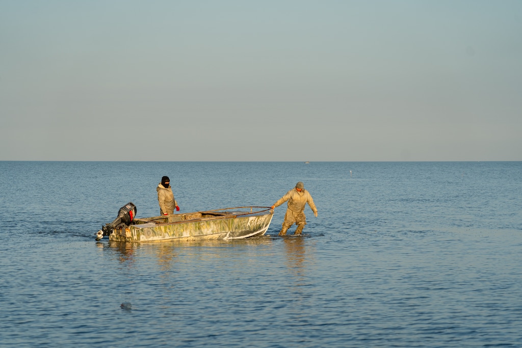 (Abduaziz Madyarov | The Great Salt Lake Collaborative) Fishermen drag their boats through the shallow waters of the Aral Sea in western Kazakhstan to a point where the water becomes deep enough to start the engines on Tuesday, Nov. 7, 2023. A failure to manage to the lake's tributaries in recent years has resulted in a steep drop in the lake's water level.