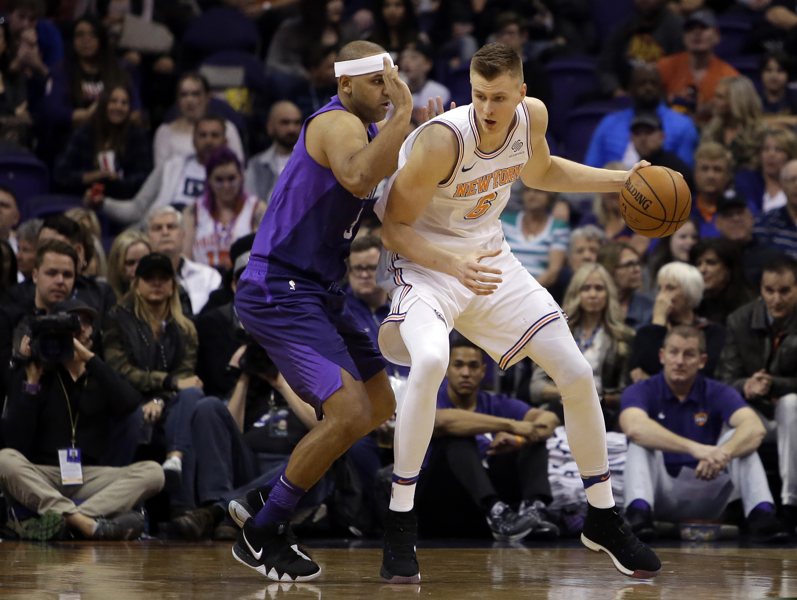FILE - In this Jan. 26, 2018, file photo, New York Knicks forward Kristaps Porzingis (6) controls the ball in the first half of an NBA basketball game against the Phoenix Suns in Phoenix. Porzingis’ left knee is healing well from a torn ACL and he will be re-evaluated in mid-February 2019. (AP Photo/Rick Scuteri, File)