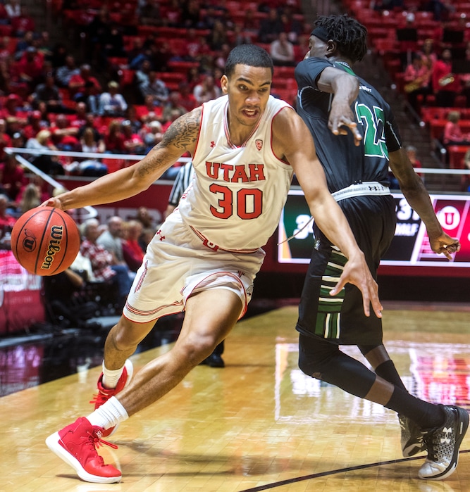 (Rick Egan  |  The Salt Lake Tribune)  Utah Utes guard Gabe Bealer (30) drives past Hawaii Warriors guard Sheriff Drammeh (23), in basketball action, Utah Utes vs Hawaii Warriors, at the Jon M. Huntsman Center, Saturday, December 2, 2017.