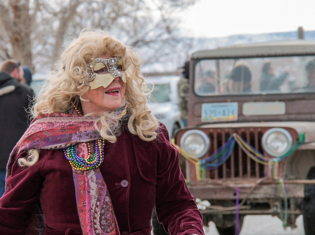 (Liz Woolsey) Sharon Mason dons a mask and beads during the Baker, Nev., Mardi Gras parade on Saturday, Feb. 10, 2024.