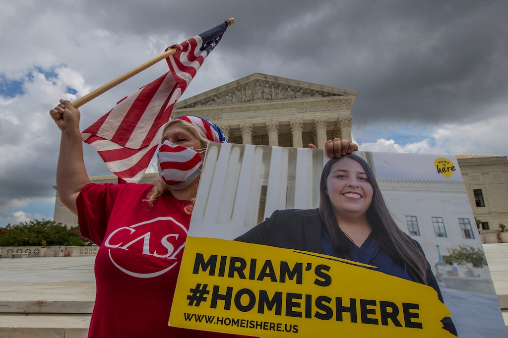 (Manuel Balce Ceneta | AP) Ivania Castillo from Prince William County, Va., holds a banner to show her support for dreamer Miriam from California, as she joins Deferred Action for Childhood Arrivals (DACA) recipients celebrate in front of the U.S. Supreme Court after the Supreme Court rejected President Donald Trump's bid to end legal protections for young immigrants, Thursday, June 18, 2020, in Washington.