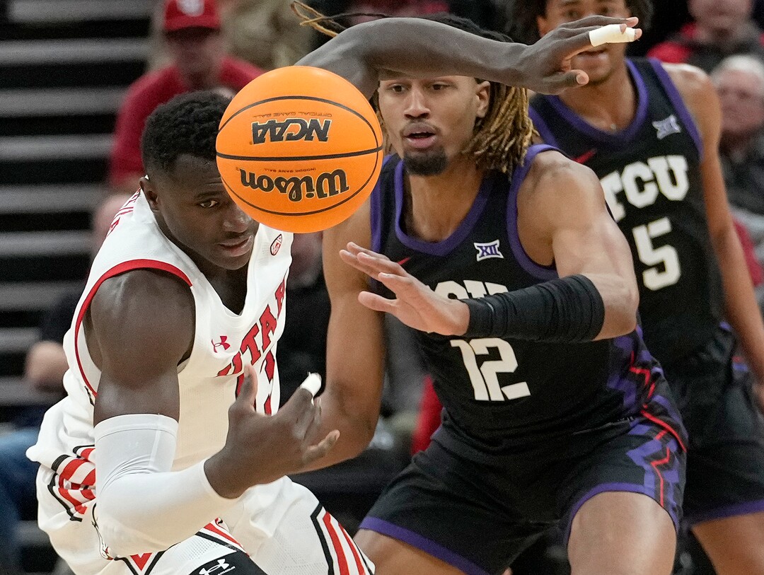 (Leah Hogsten | The Salt Lake Tribune) Utah Utes center Keba Keita (13) and TCU Horned Frogs forward Xavier Cork (12) fight for possession as the University of Utah hosts the TCU Horned Frogs at Vivint Arena, Dec. 21, 2022. 