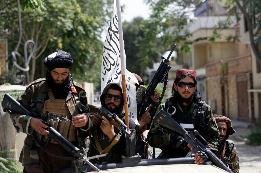 (Rahmat Gul | AP) Taliban fighters display their flag on patrol in Kabul, Afghanistan, Thursday, Aug. 19, 2021. The Taliban celebrated Afghanistan's Independence Day on Thursday by declaring they beat the United States, but challenges to their rule ranging from running a country severely short on cash and bureaucrats to potentially facing an armed opposition began to emerge.