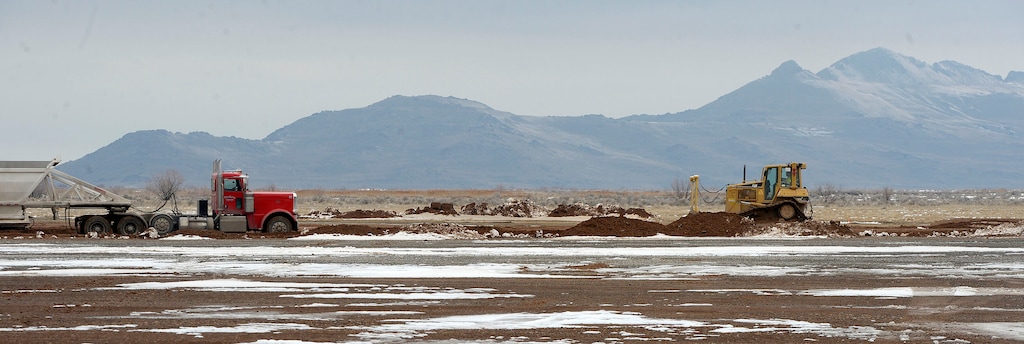 (Al Hartmann | The Salt Lake Tribune)
Trucks with trailers dump their loads of 40-45 tons of fill dirt on the new state prison site Tuesday Feb. 27. Graders follow behind to smooth the new fill dirt in. No repeat this 300 to 350 time a day. The fill project is about a week from completion at the new prison site northwest of Salt Lake City and state and city leaders are hoping to use road and utility line improvements as an anchor for converting the area into an international trade hub.