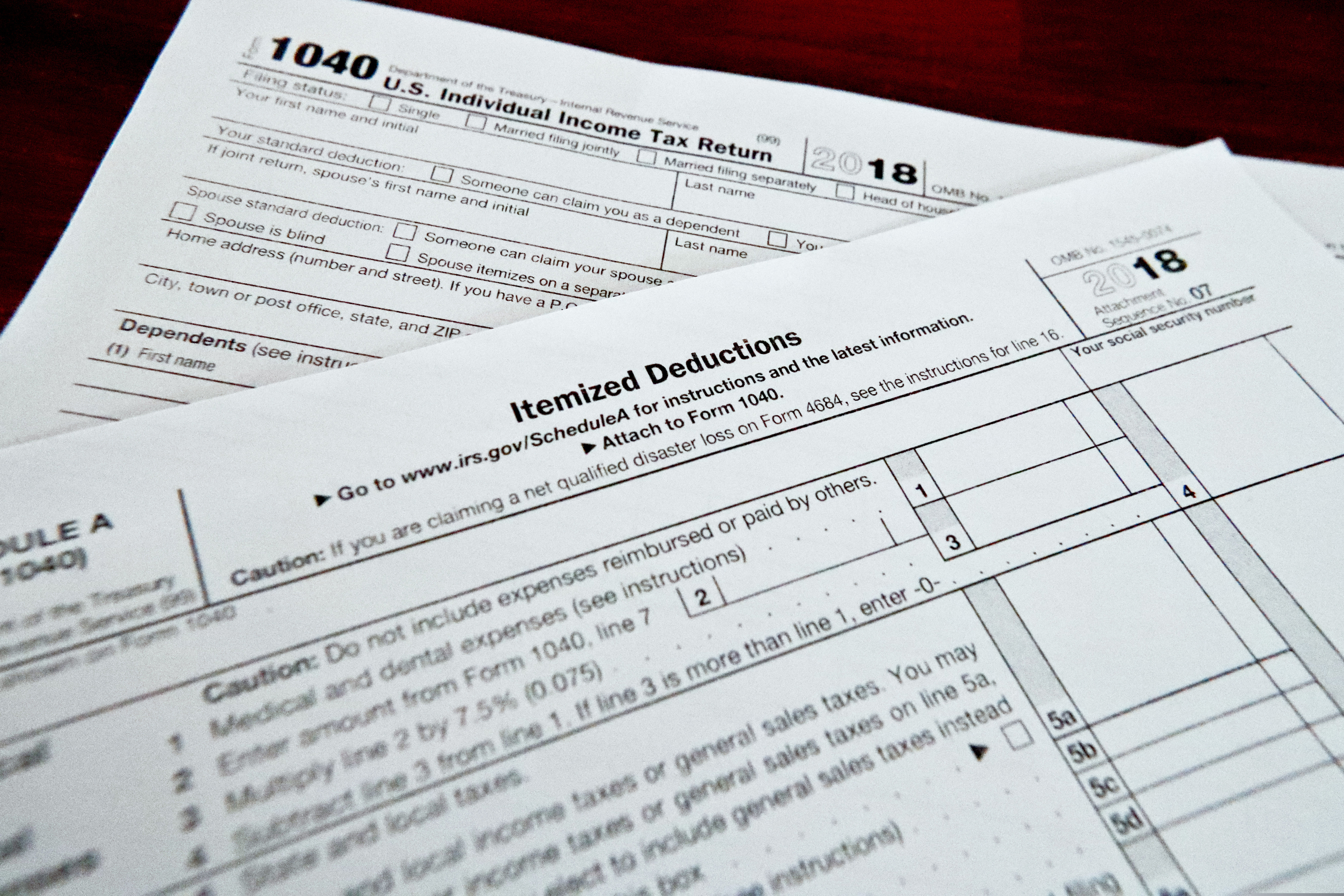 This Feb. 13, 2019, shows multiple forms printed from the Internal Revenue Service web page that are used for 2018 U.S. federal tax returns in Zelienople, Pa. For taxpayers who itemize, the 2 percent miscellaneous itemized deduction was a handy catchall bucket for expenses such as investment fees and expenses and tax-preparation fees. It wasn’t easy to qualify for this deduction, your expenses had to top 2 percent of your adjusted gross income before you could claim them, but it was a nice option to have. (AP Photo/Keith Srakocic)