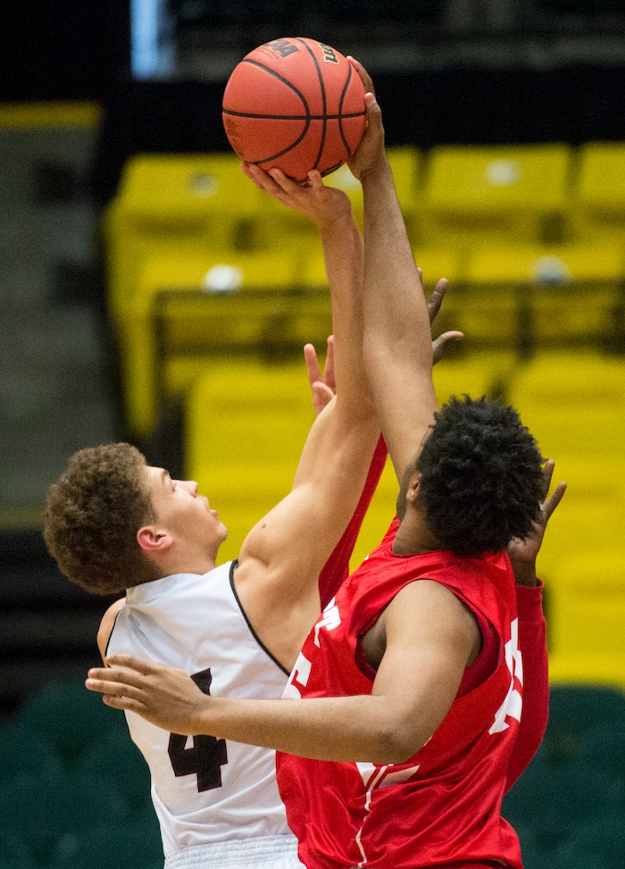 (Rick Egan  |  The Salt Lake Tribune)   East Leopards Mikey Frazier (45) blocks a shot by Jordan Beatdiggers Dyson Koehler (4), in 5A basketball playoff action between the East Leopards and the Jordan Beatdiggers at the UCCU Center in Orem, Monday, Feb. 26, 2018.