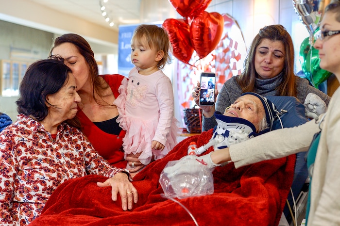 Leah Hogsten  |  The Salt Lake Tribune  l-r Lucia Silva, daughter Flavia Beare, granddaugher Petra Beare, and family friend Cristina Tesolin weep as they tend to their husband and father, Osvaldo Silva. On Friday, Intermountain Hospital caregivers wheeled paralyzed cancer patient Osvaldo Silva, 85, down to the lobby for a personal piano concert in his honor, Feb. 15, 2019. With tears streaming down his face, Osvaldo, who is from Brazil, was treated to a dozen songs played by his Church of Jesus Christ of Latter-day Saints bishop, Bispo Do Pai Valdir, who kicked off the set with none other than ÒThe Girl from Ipanema.Ó  