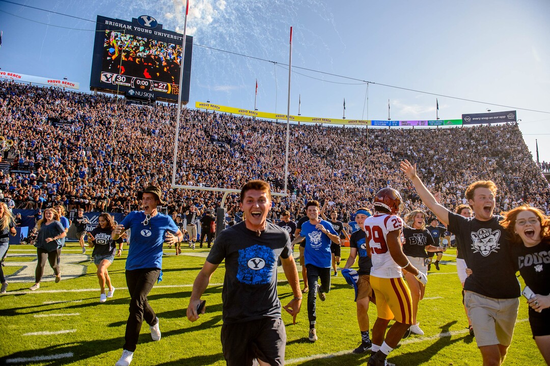 (Trent Nelson  |  The Salt Lake Tribune)  BYU fans rush the field to celebrate the overtime win as BYU hosts USC, NCAA football in Provo on Saturday Sept. 14, 2019.