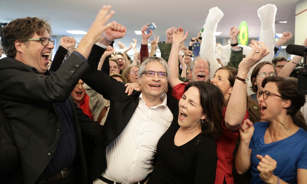 Green party chairwoman Annalena Baerbock and EU parliament member Sven Giegold celebrate after the first results in Berlin, Germany, Sunday, May 26, 2019. (Kay Nietfeld/dpa via AP)