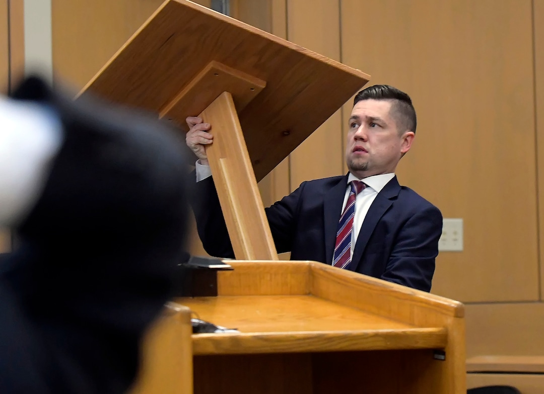 Prosecuting attorney Spencer Walsh sets up a podium, preparing for closing arguments in Torrey Green's rape trial, Wednesday, Jan.16, 2019 in Brigham City, Utah. Green is accused of raping multiple women while he was a football player at Utah State University. (Eli Lucero/Herald Journal via AP)
