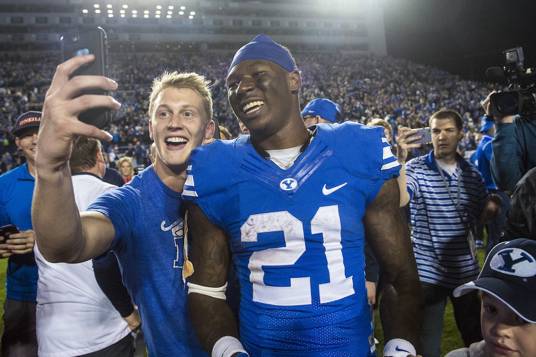 BYU fans take selfies with running back Jamaal Williams (21) after their 28-21 in double overtime win against Mississippi State in an NCAA college football game in Provo, Utah, Friday, Oct. 14, 2016. (Chris Detrick/The Salt Lake Tribune via AP)