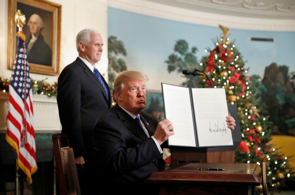 (AP Photo/Alex Brandon) President Donald Trump, accompanied by Vice President Mike Pence, holds up a signed proclamation recognizing Jerusalem as the capital of Israel in the Diplomatic Reception Room of the White House, Wednesday, Dec. 6, 2017, in Washington.