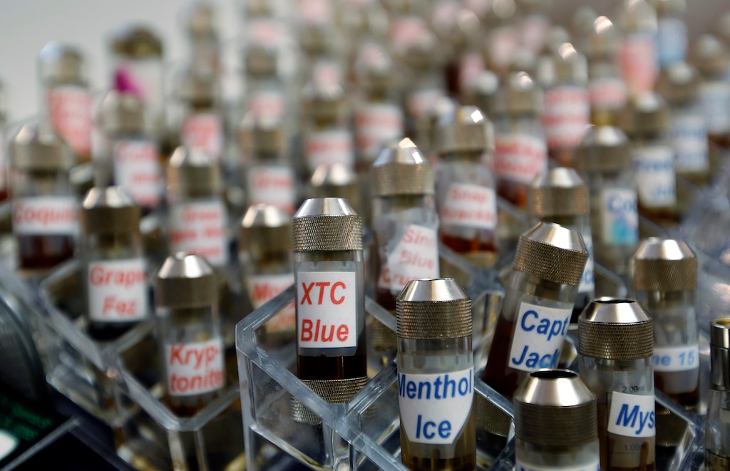 FILE - This Dec. 4, 2013 file photo shows vials of flavored liquid at a store selling electronic cigarettes and related items in Los Angeles. On Wednesday, Sept. 12, 2018, U.S. health officials said teenage use of e-cigarette has reached “epidemic” levels in the U.S. and are calling on the industry to address the problem or risk having their flavored products pulled off the market. (AP Photo/Reed Saxon, File)