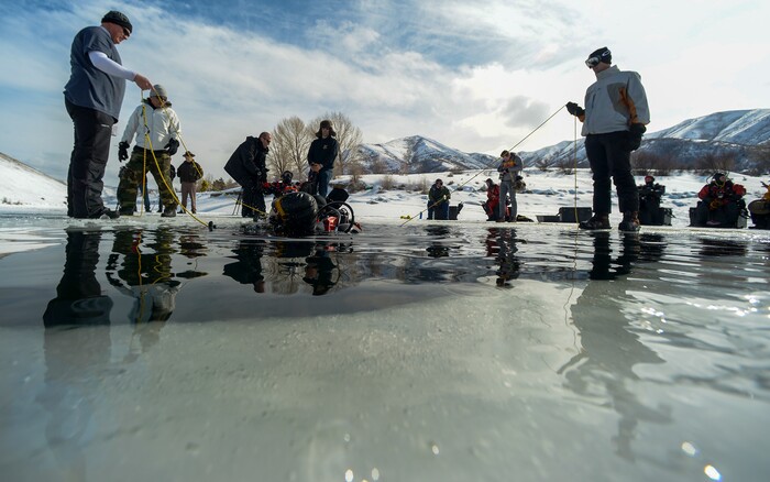 Leah Hogsten | The Salt Lake Tribune The Utah Department of Public Safety's Dive Team and the Riverside County Sheriff's Office joined forces for a day of ice diving at Deer Creek Reservoir, Feb. 20, 2019. Twenty members from Riverside County Sheriff's Department dove in icy waters alongside DPS' 10 man team in a joint team training day, Wednesday. Members of the Riverside County Sheriff's were working to become certified in ice diving under the team's lieutenant and dive master. Due to the equipment assets and the unique diver skill sets, dive teams are often called upon to provide assistance to aquatic homicide investigations and accidental drownings.