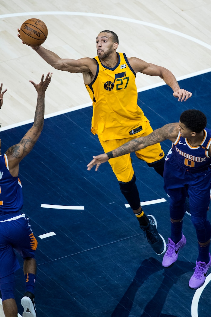 (Chris Detrick  |  The Salt Lake Tribune)  Phoenix Suns guard Elfrid Payton (2) Utah Jazz center Rudy Gobert (27) and Phoenix Suns forward Marquese Chriss (0) go for the ball during the game at Vivint Smart Home Arena Thursday, March 15, 2018. 