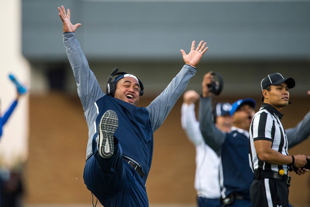 (Chris Detrick  |  The Salt Lake Tribune)  Brigham Young Cougars running backs coach Reno Mahe celebrates a touchdown during the game at Merlin Olsen Field at Maverik Stadium Friday, September 29, 2017.