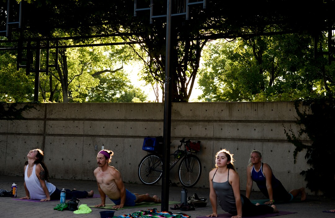 (Leah Hogsten  |  The Salt Lake Tribune) Dozens of yoga enthusiasts filled the Ogden Amphitheater on Thursday, July 25, 2019 during the annual free yoga class sponsored by the Front Yoga Loft and The Front Climbing Club. Nine instructors from the Front Yoga Loft led the crowd as the music of guitarist Julian Alvarez played in the background.