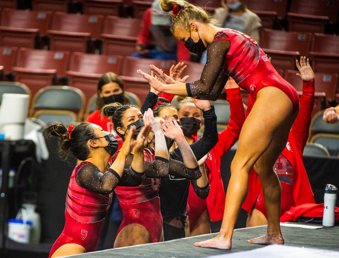 (Rick Egan | The Salt Lake Tribune) Team mates congratulate Abby Paulson after her performance on the beam for Utah in the Best of Utah gymnastics meet at the Maverik Center on Saturday, Jan. 9, 2021.