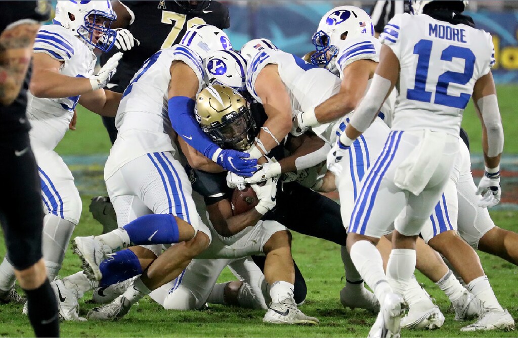 Central Florida running back Bentavious Thompson is stopped late in the first quarter against BYU in the Boca Raton Bowl NCAA college football game Tuesday, Dec. 22, 2020, in Boca Raton, Fla. (Mike Stocker/South Florida Sun-Sentinel via AP)