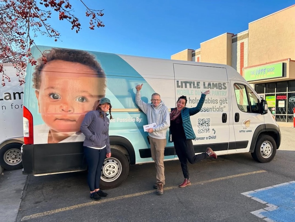 (Stefanee Chalfant | Little Lambs Foundation for Kids) Volunteers for Little Lambs standing in front of one of the nonprofit's delivery trucks.