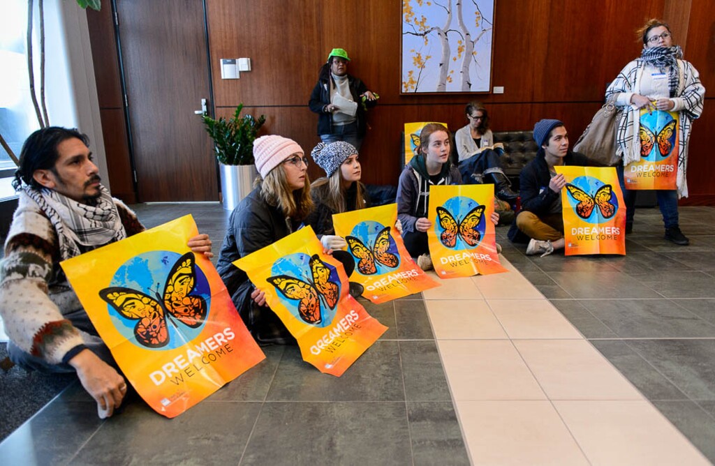 (Trent Nelson | The Salt Lake Tribune) A group of protesters hold a short sit-in at the Wallace F. Bennett Federal Building in Salt Lake City Tuesday December 5, 2017, asking federal representatives to include a clean DREAM Act in the Omnibus Spending bill, or to vote against the Spending Bill should DACA protection not be included.