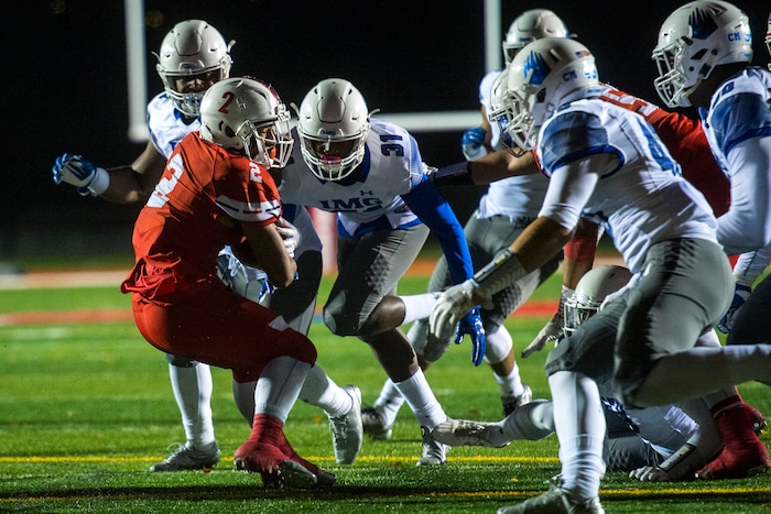 (Chris Detrick  |  The Salt Lake Tribune)  East's Sione Molisi (2) scores a touchdown past IMG Academy's Mikel Anthony Jones (31) during the game at East High School Friday, October 20, 2017. 