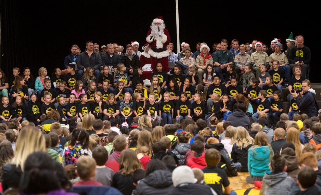 (Rick Egan  |  The Salt Lake Tribune) Flanked by pilots and Boy Scouts, Santa talks to the students at Centennial Elementary School, in Roosevelt, Utah, as volunteer pilots from the Utah Wing of Angel Flight West, brought school supplies and gifts to students on their annual Santa Flight. Friday, December 8, 2017.