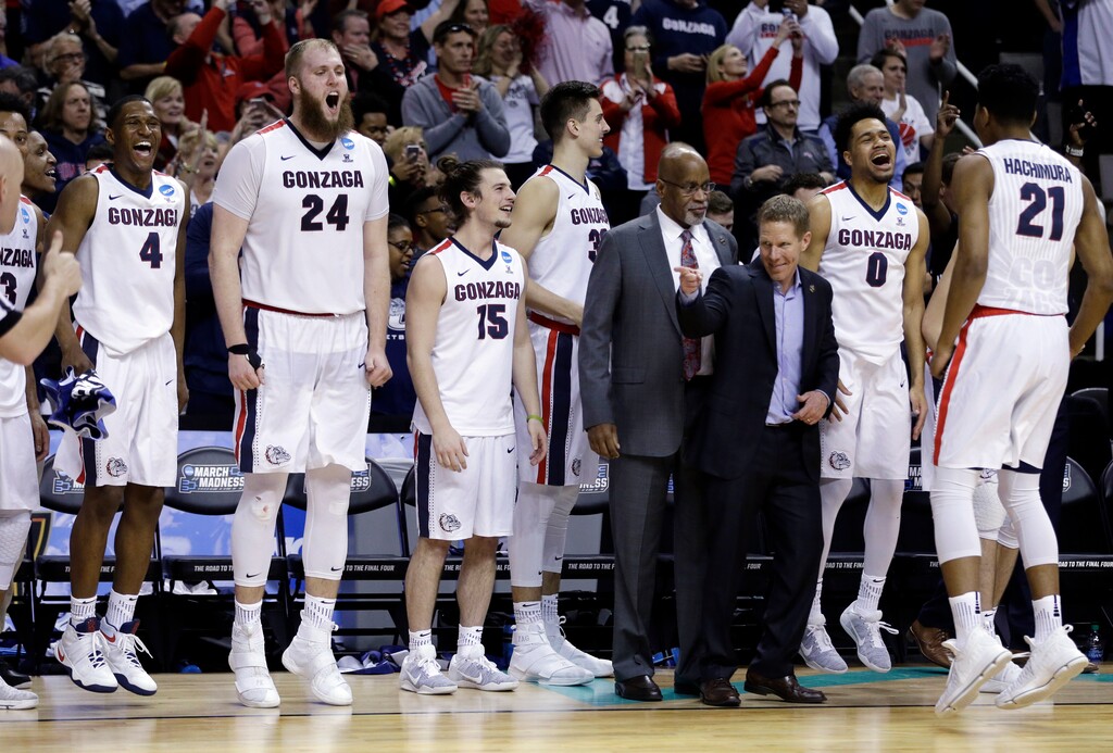 Gonzaga players and coaches celebrate in the closing minutes of a win over Xavier during the second half of an NCAA Tournament college basketball regional final game Saturday, March 25, 2017, in San Jose, Calif. (AP Photo/Ben Margot)