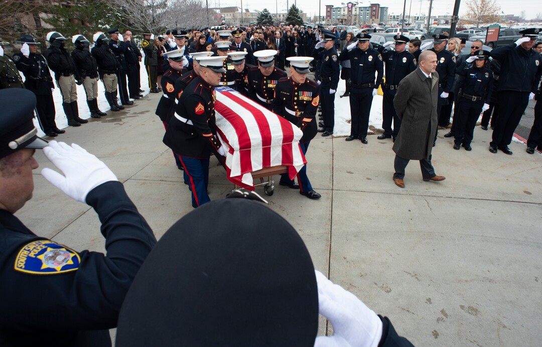 (Rick Egan  |  The Salt Lake Tribune)     Pall Police officers salute, as the pall bearers bring the casket out of the Maverik Center, after David Romrell 's funeral in West Valley City, Wednesday, Dec. 5, 2018.