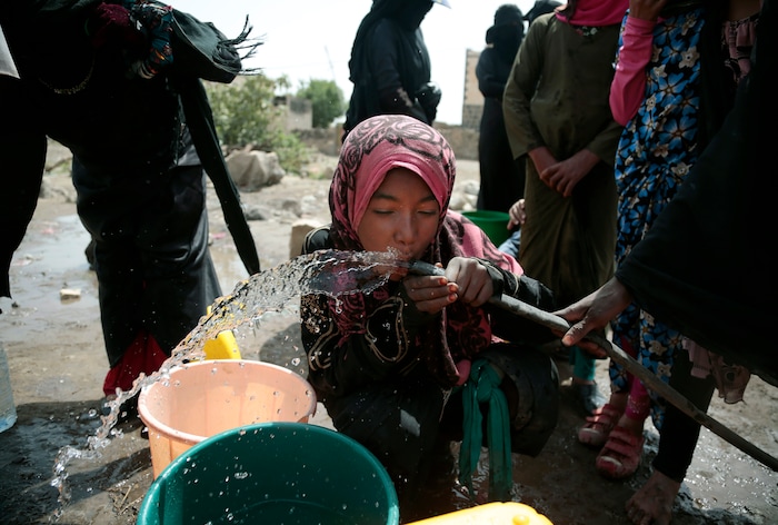 In this photo taken on Wednesday, Jul. 12, 2017, a girl drinks water from a well that alleged to be contaminated water with the bacterium Vibrio cholera, on the outskirts of Sanaa, Yemen. Yemen’s raging two-year conflict has served as an incubator for lethal cholera. (AP Photo/Hani Mohammed)