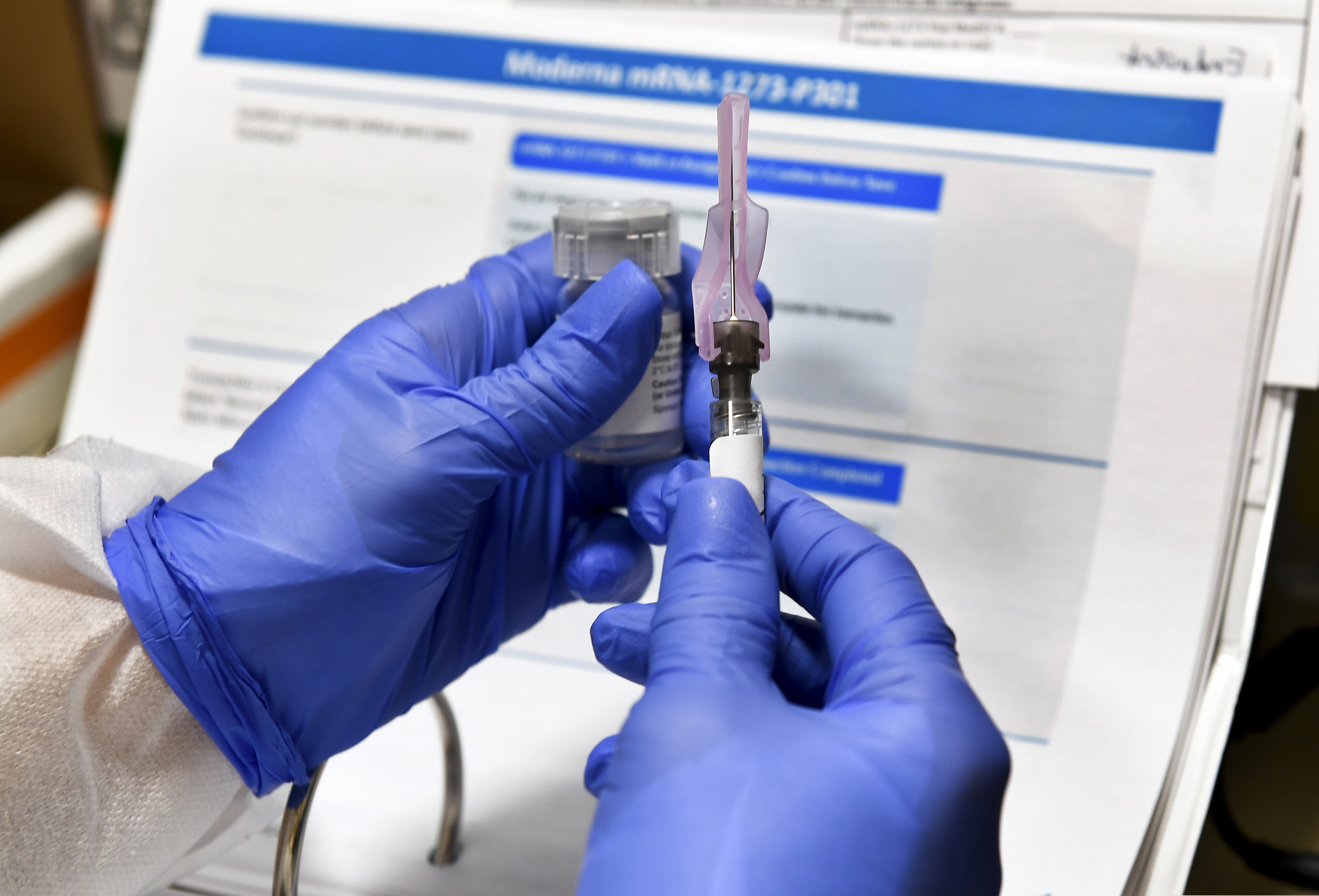 (Hans Pennink | Associated Press file photo) A nurse in July prepares a shot for a potential COVID-19 vaccine, being developed by the National Institutes of Health and Moderna Inc. Health officials in Utah are awaiting federal approval of Moderna's vaccine and a similar vaccine by Pfizer Inc. which they hope to start distributing to Utah health care workers as soon as December 2020 or January 2021.