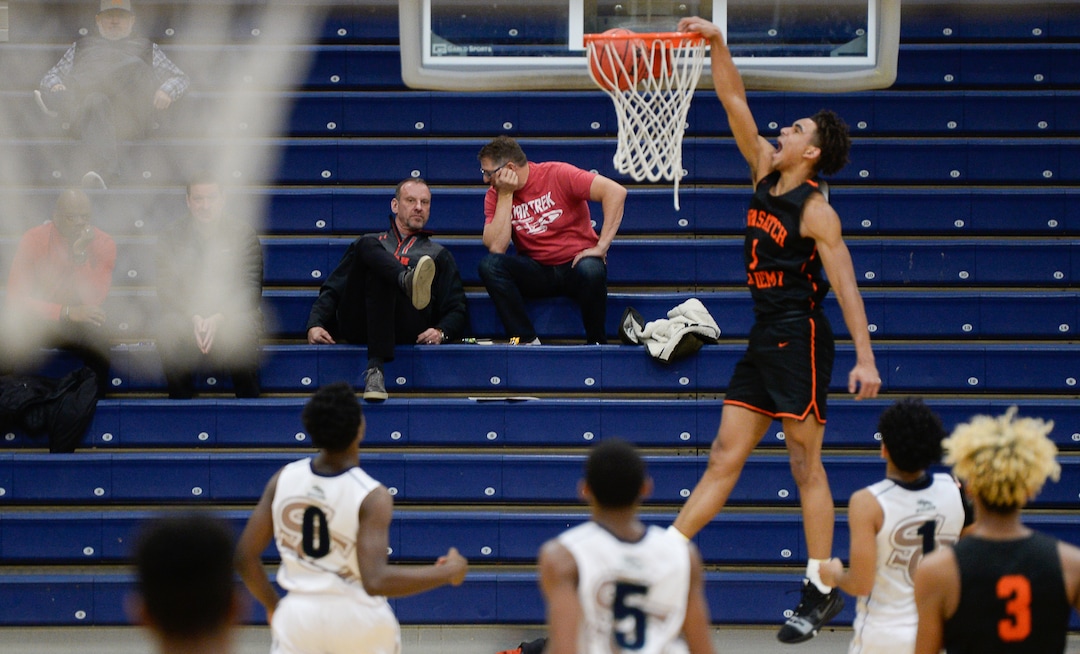 (Francisco Kjolseth  |  The Salt Lake Tribune)  Tre Williams of Wasatch Academy dunks a basket as Utah head coach Larry Krystkowiak, left, watches the game against South County High from the bleachers during a recent tournament at Orem High. Wasatch Academy is ranked No. 2 by MaxPreps. Tre Williams, who is being recruited by colleges recently signed. 