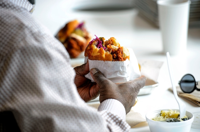 (Steve Griffin  |  The Salt Lake Tribune)  Patrons enjoy the chicken sandwich at Pretty Bird, a new Nashville-style hot chicken restaurant on Regent Street, in Salt Lake City Monday April 23, 2018.