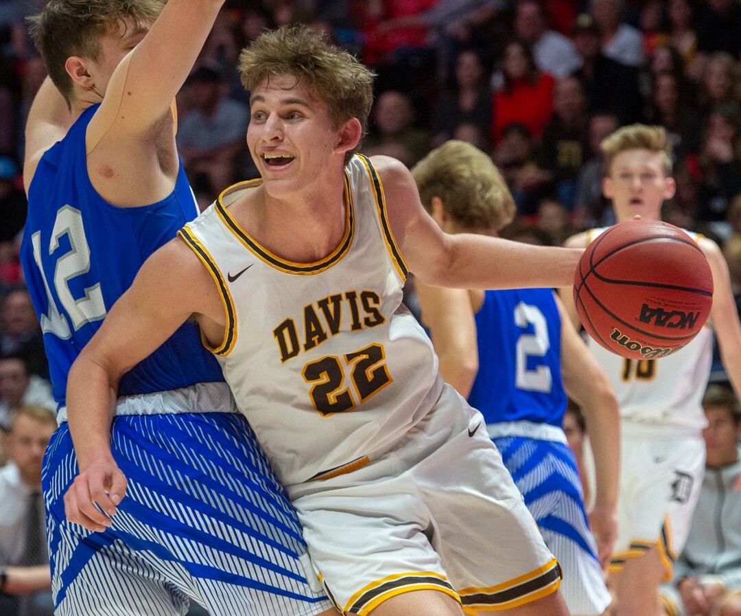 (Rick Egan  |  The Salt Lake Tribune)   Davis High forward Jax Pearce (22)   drives under the basket as Silverwolves Mitch Stratford (12) defends, in the 6A championship game at the Jon M. Huntsman Center, Saturday Feb. 29, 2020