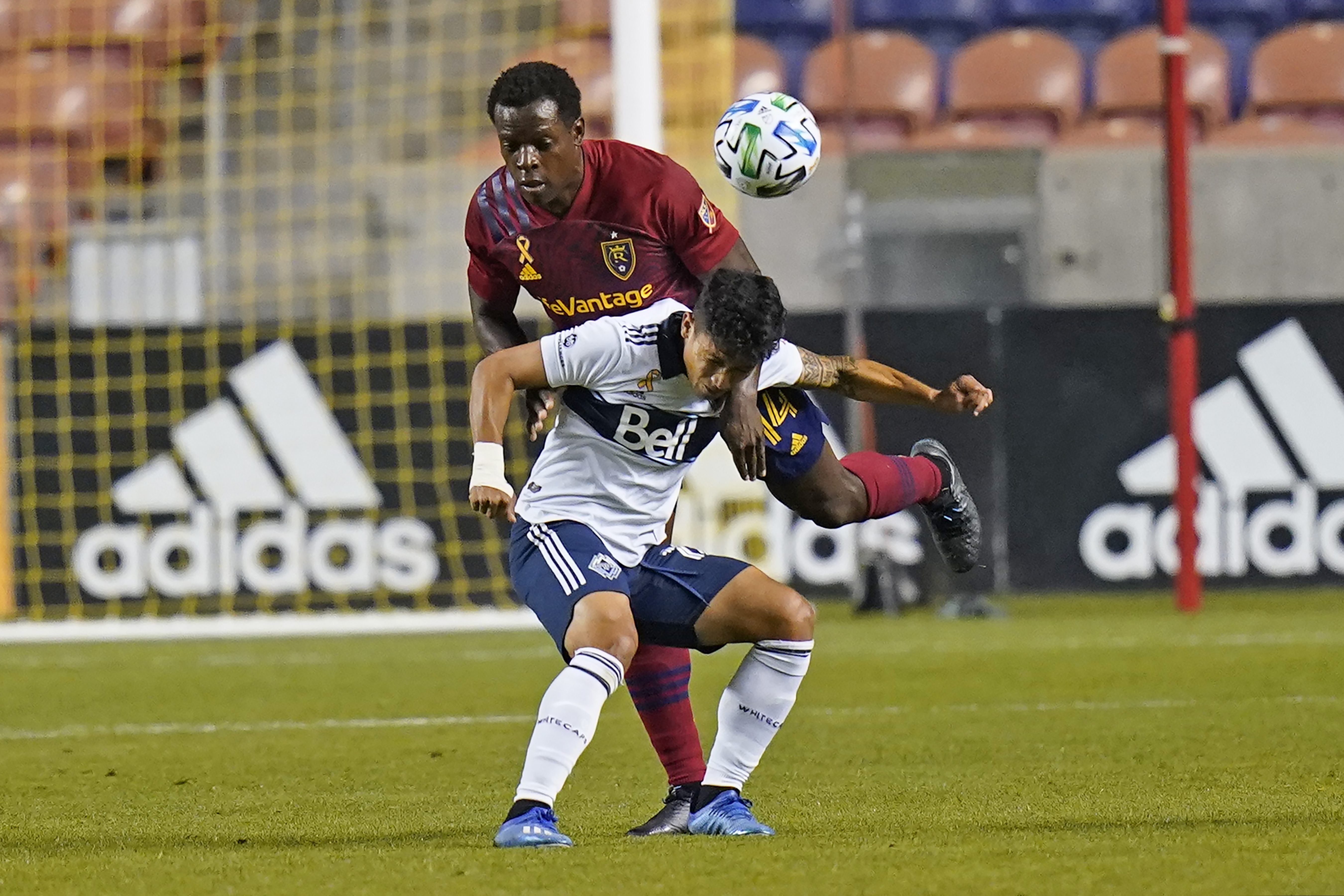 Real Salt Lake defender Nedum Onuoha (14) battle with Vancouver Whitecaps forward Fredy Montero, foreground, in the first half during an MLS soccer match Saturday, Sept. 19, 2020, in Sandy, Utah. (AP Photo/Rick Bowmer)