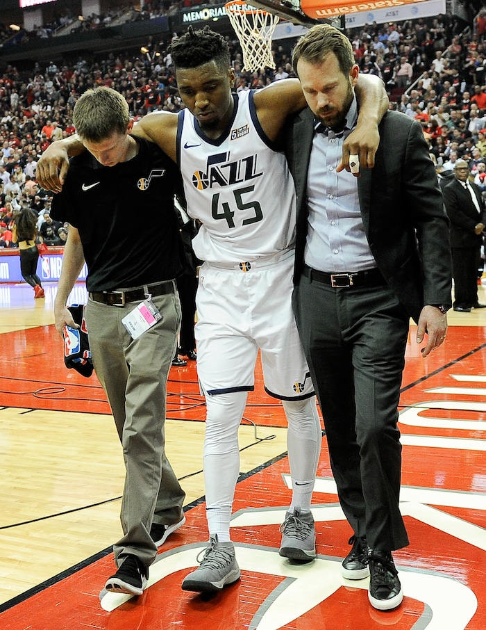 Utah Jazz guard Donovan Mitchell (45) is helped off the court after sustaining an injury during the second half in Game 5 of an NBA basketball second-round playoff series against the Houston Rockets, Tuesday, May 8, 2018, in Houston. (AP Photo/Eric Christian Smith)