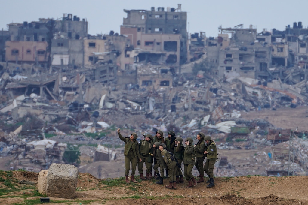 (Tsafrir Abayov | The Associated Press) Israeli female soldiers pose for a photo on a position on the Gaza Strip border, in southern Israel, Monday, Feb. 19, 2024.