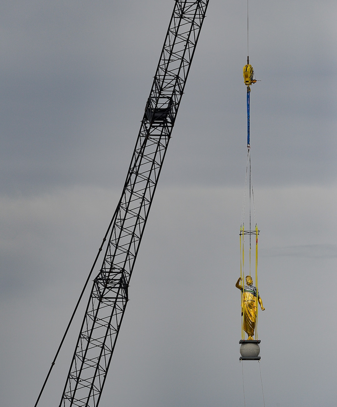 (Francisco Kjolseth  |  The Salt Lake Tribune) Crews work to remove the Angel Moroni statue atop the Salt Lake Temple of The Church of Jesus Christ of Latter-day Saints on Monday, May 18, 2020. The temple closed in December for seismic upgrades and sustained minor damager during the March 18, 2020, magnitude 5.7 earthquake when the trumpet held by the angel fell off and several smaller spire stones were displaced.