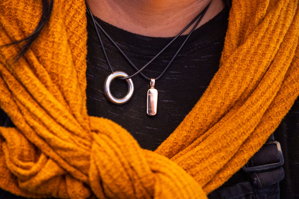 (Jud Burkett | Special to The Tribune) Valerie Jones wears jewelry containing a portion of the ashes of her siblings at Solomon's Porch Four Square Church in St. George, Sunday, March 10, 2024. Jones' two younger siblings, Mardelle Parkin and Matthew Jones, were killed in two separate auto-pedestrian accidents at the same St. George intersection just a few days apart in November of 2023.