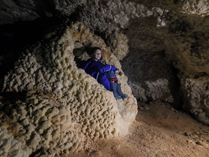 (Erin Alberty  |  The Salt Lake Tribune)

Robert Cope, 12, perches gingerly on a degraded section of this throne of calcite in Crystal Ball Cave in Gandy, Utah.