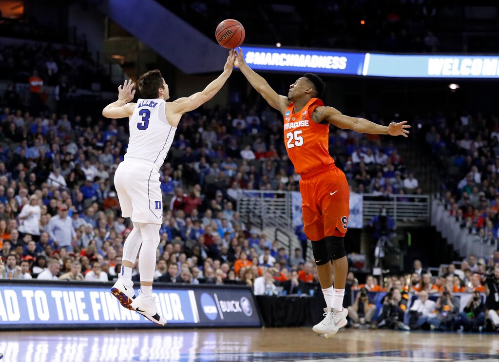 Duke's Grayson Allen (3) and Syracuse's Tyus Battle (25) reach for the ball during the first half of a regional semifinal game in the NCAA men's college basketball tournament Friday, March 23, 2018, in Omaha, Neb. (AP Photo/Nati Harnik)