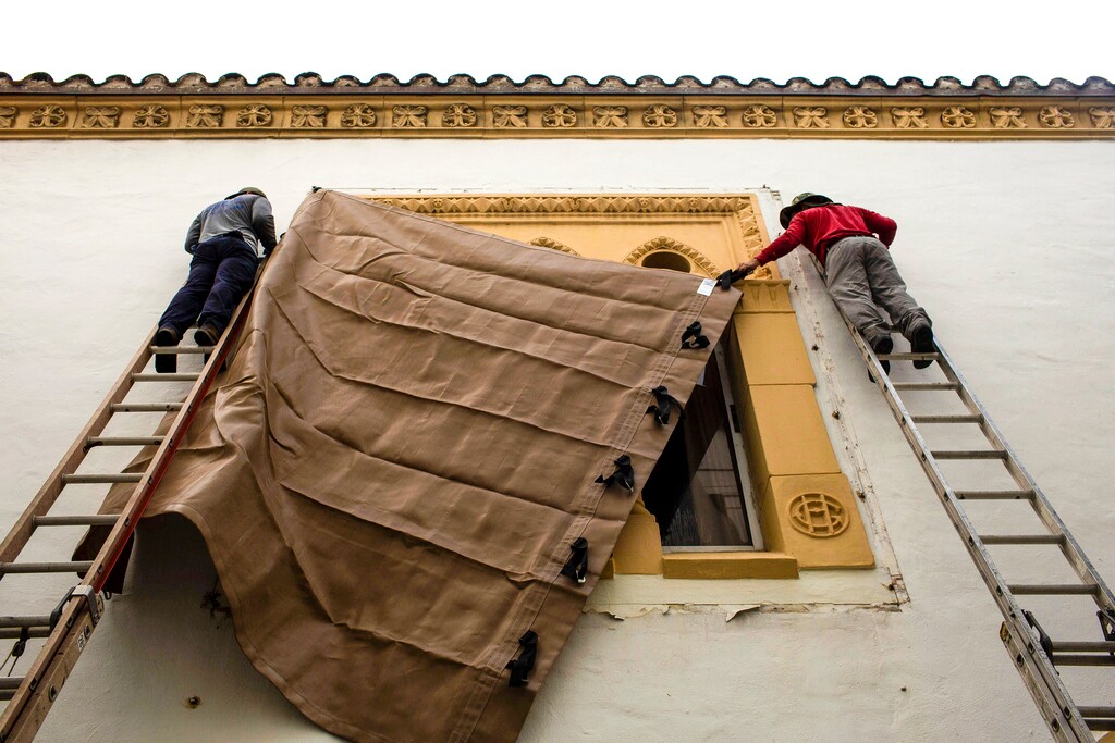(Saul Martinez | The New York Times) Workers install window coverings in Palm Beach, Fla., in preparation for Hurricane Dorian on Friday morning, Aug. 30, 2019.  Forecasters expect Hurricane Dorian to arrive somewhere along the east coast of Florida on Monday afternoon.