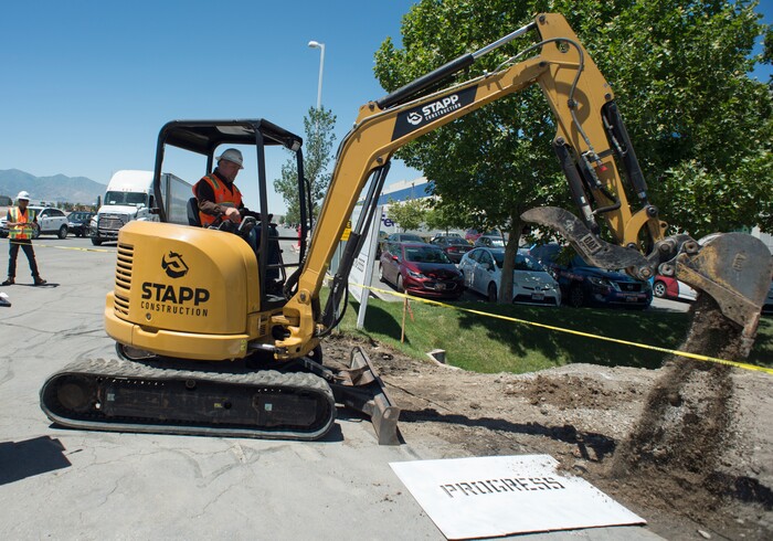 (Rick Egan | The Salt Lake Tribune) Rio Honker, Job Superintendent for Stapp Construction, takes a scoop of dirt during a news conference announcing the start of the city’s 2018 road construction season at 720 South Gladiola Street. A total of ten projects are scheduled for completion by the City’s Engineering Division through a combined investment of $5 million. Monday, June 11, 2018.