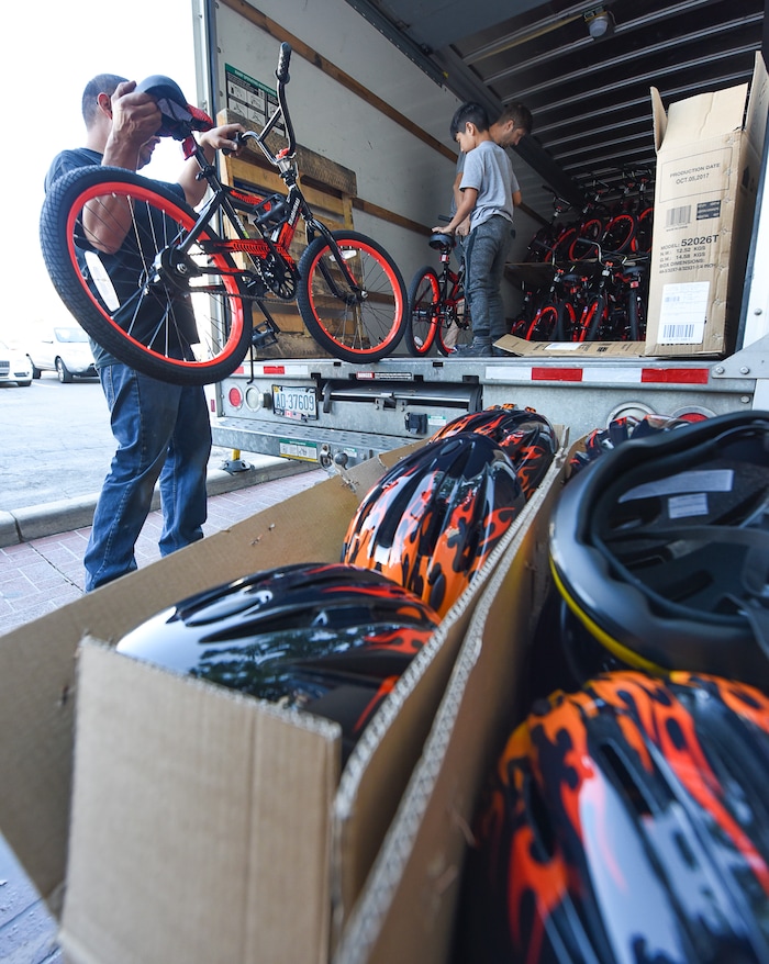 (Francisco Kjolseth  |  The Salt Lake Tribune)  Volunteers and workers at Squatter's Pub Brewery assemble 80 bicycles on Tuesday, May 29, 2018, at the brewery which will be given away to 1st and 2nd graders at Washington Elementary on Wednesday as they are loaded onto a truck. Part of the program is backed by the Can'd Aid Foundation.