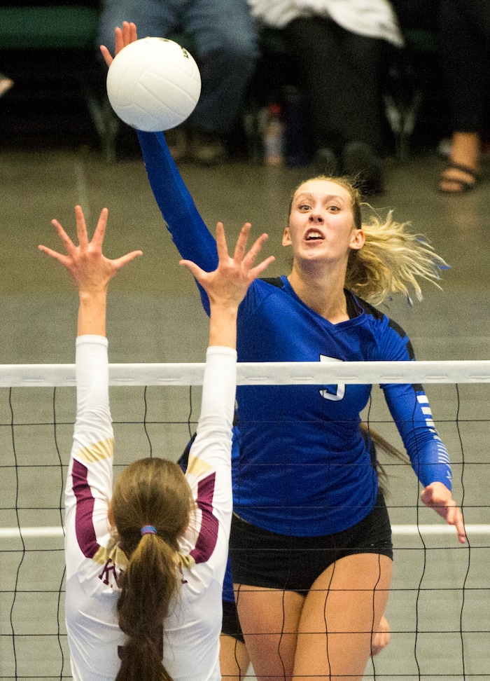 (Rick Egan  |  The Salt Lake Tribune)   Pleasant Grove Vikings Heather Gneiting (5) hits the ball, as Pleasant Grove Vikings Lone Peak Knights  Madelyn Robinson (9) defends, in 6A volleyball championship action, Pleasant Grove vs. Lone Peak, at Utah Valley University, Saturday, November 4, 2017.