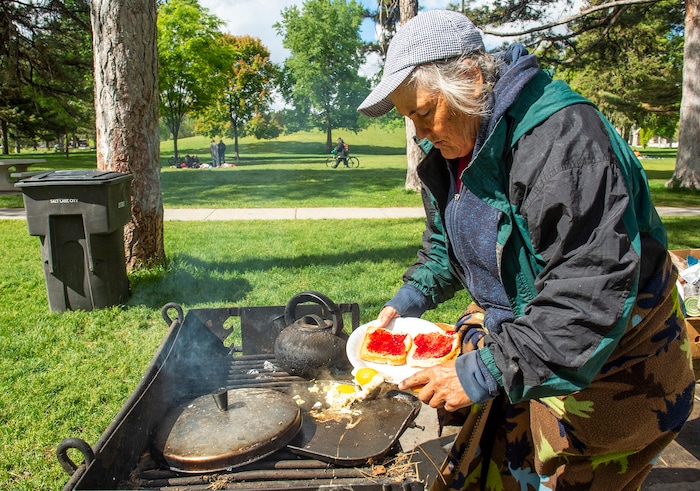 (Rick Egan  |  The Salt Lake Tribune)     Rosie Webster cooks some eggs and toast at Liberty Park, Saturday, May 23, 2020.