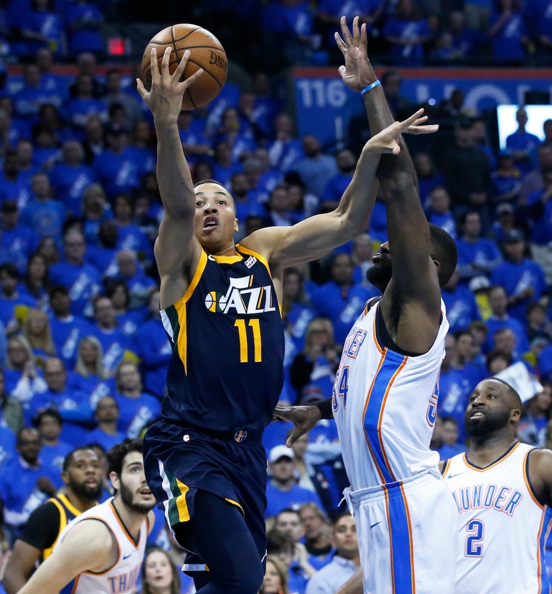 Utah Jazz guard Dante Exum (11) shoots in front of Oklahoma City Thunder forward Patrick Patterson, right, in the second half of Game 1 of an NBA basketball first-round playoff series in Oklahoma City, Sunday, April 15, 2018. (AP Photo/Sue Ogrocki)